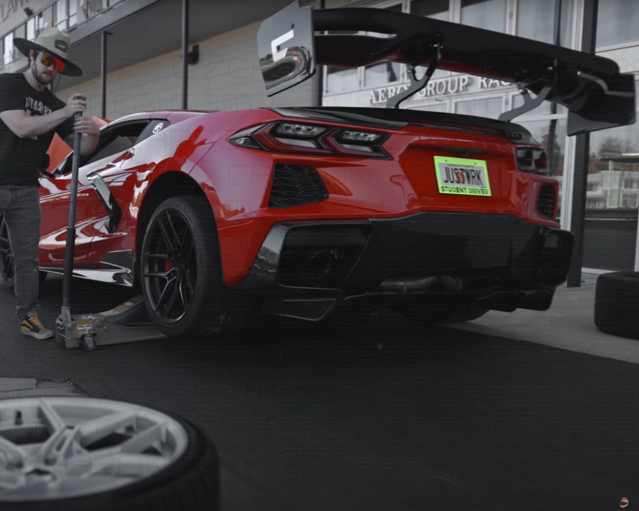 Rear view of Corvette C8 Z06 with a mounted rear spoiler during a track setup.